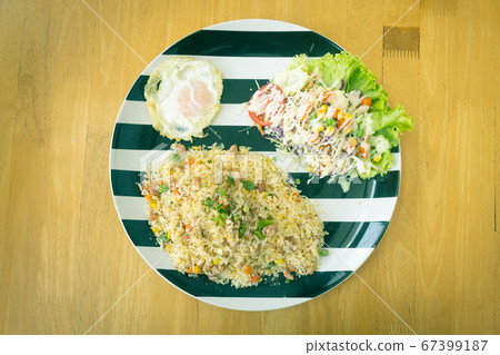 Sour Pork Fried Rice and Salad and Fried Egg on Top View in Vintage Tone Sour Pork Fried Rice and Salad and Fried Egg on Top View in Vintage Tone 67399187