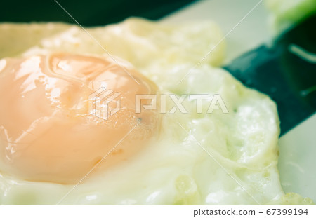 Fried Egg on Dish with Natural Light in Close Up View in Vintage Tone 67399194