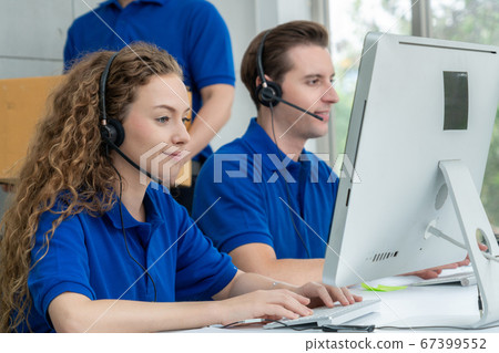 Business people wearing headset working in office Business people wearing headset working in office 67399552