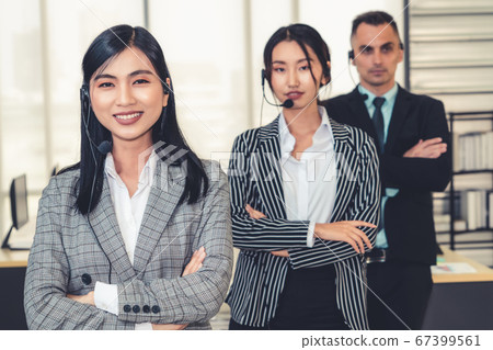 Business people wearing headset working in office Business people wearing headset working in office 67399561