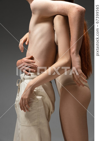 Portrait of beautiful redhead couple isolated on grey studio background. Concept of beauty, skin care, fashion and style Portrait of beautiful redhead couple isolated on grey studio background. Concept of beauty, skin care, fashion and style 67399565