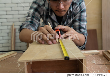 Carpenter working on wood craft at workshop Carpenter working on wood craft at workshop 67399675