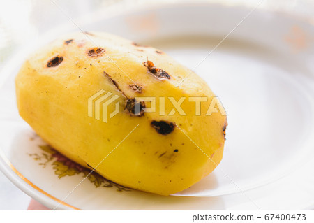 Big peeled new potatoes, yellow potatoes on a 67400473