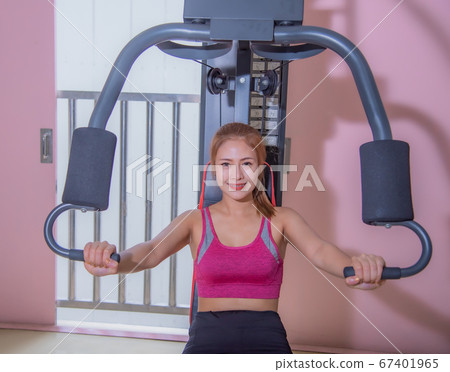 Young woman workout in gym healthy lifestyle. Young women play sports in the gym to exercise Young woman workout in gym healthy lifestyle. Young women play sports in the gym to exercise 67401965