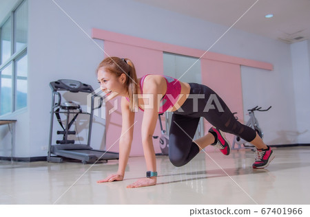 Asian woman exercising in the gym, She was pretending to "plank" Asian woman exercising in the gym, She was pretending to "plank" 67401966