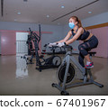 A sports girl is pushing up in a medical mask during a pandemic. COVID-19. Health care. 67401967