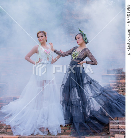 Thai Woman wearing Thai Traditional Dress in the old temple and pagoda of Thailand Thai Woman wearing Thai Traditional Dress in the old temple and pagoda of Thailand 67401969