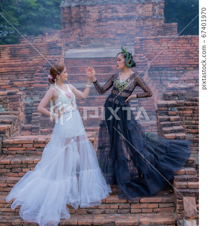 Thai Woman wearing Thai Traditional Dress in the old temple and pagoda of Thailand Thai Woman wearing Thai Traditional Dress in the old temple and pagoda of Thailand 67401970
