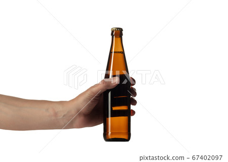 Empty golden colored beer bottle in male hand. Isolated on white studio background Empty golden colored beer bottle in male hand. Isolated on white studio background 67402097