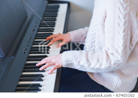 Girl playing the piano at home ahead of going out [New normal of Wiscorona] 67403102