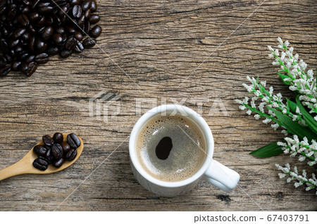 Coffee cup and coffee beans roasted in a sack on a Coffee cup and coffee beans roasted in a sack on a 67403791