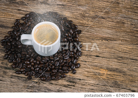 Coffee cup and coffee beans roasted in a sack on a Coffee cup and coffee beans roasted in a sack on a 67403796