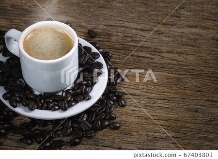 Coffee cup and coffee beans roasted in a sack on a 67403801