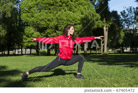 girl in a red jacket engaged in sports, yoga in girl in a red jacket engaged in sports, yoga in 67405472