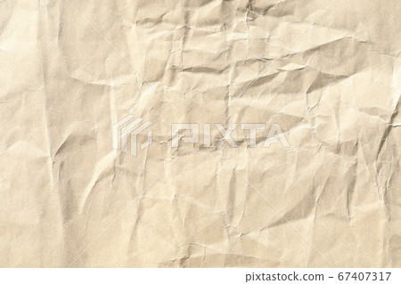 Crumpled brown paper background texture Crumpled brown paper background texture 67407317