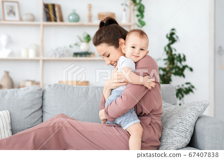 Bonding With Baby. Loving Mom Cuddling Her Adorable Toddler Son At Home Bonding With Baby. Loving Mom Cuddling Her Adorable Toddler Son At Home 67407838