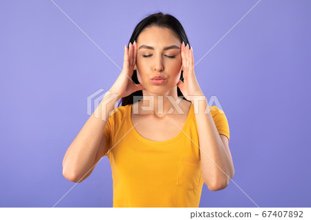 Woman practicing breathing yoga exercise at the studio 67407892