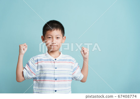 happy Asian little boy standing on blue background isolated happy Asian little boy standing on blue background isolated 67408774