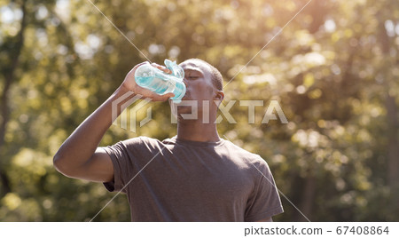 Black man drinking water, suffering from hot weather Black man drinking water, suffering from hot weather 67408864