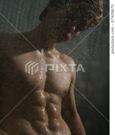 Nude young man under water stream studio portrait Nude young man under water stream studio portrait 67409670