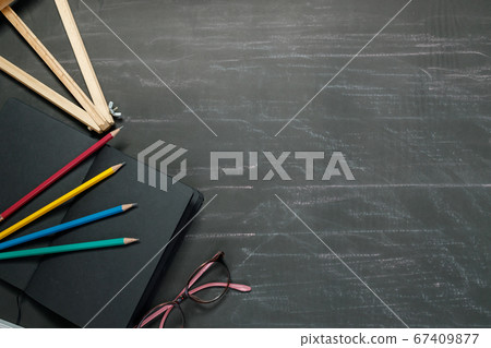 School supplies on black board background. 67409877