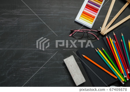 School supplies on black board background. 67409878