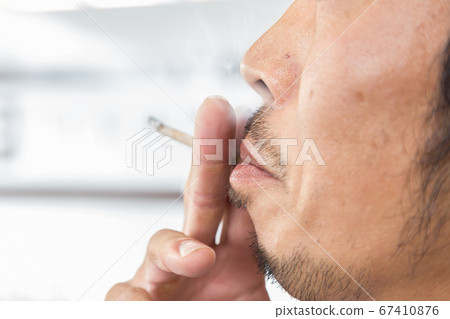 The mouth of a man who smokes 67410876
