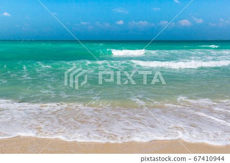 Soft Blue Ocean Wave On Sandy Beach. Background. Soft Blue Ocean Wave On Sandy Beach. Background. 67410944