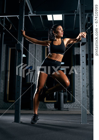 Fitnesswoman posing in gym. 67410999