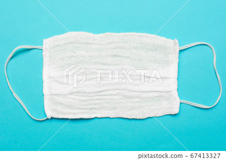 Prevent coronavirus. Medical mask isolated on blue background. Disposable surgical face mask cover mouth and nose. Healthcare medical COVID-2019 quarantine, hygiene concept. 67413327