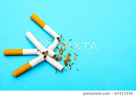 World No Tobacco Day. Concept of healthy lifestyles without cigarettes on the blue background. World No Tobacco Day. Concept of healthy lifestyles without cigarettes on the blue background. 67413339