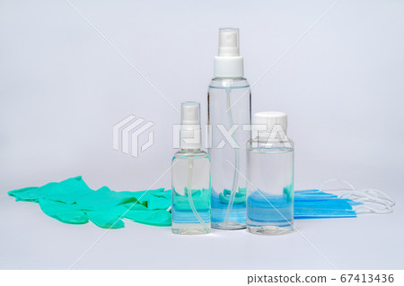 bottle of lotion, sanitizer or liquid soap and protective mask over light grey background bottle of lotion, sanitizer or liquid soap and protective mask over light grey background 67413436