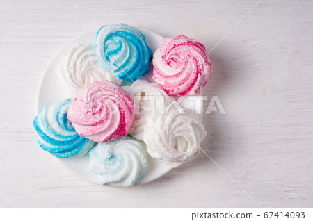 Homemade sweet colored meringue on white Homemade sweet colored meringue on white 67414093