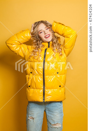Winter woman wearing season down jacket on vivid Winter woman wearing season down jacket on vivid 67414104