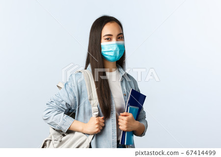 Covid-19 pandemic, education during coronavirus, back to school concept. Stylish modern asian female student at college, carry backpack and notebooks studying material, look camera Covid-19 pandemic, education during coronavirus, back to school concept. Stylish modern asian female student at college, carry backpack and notebooks studying material, look camera 67414499