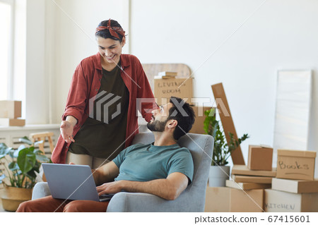 Couple using laptop at home Couple using laptop at home 67415601