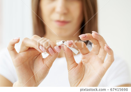 Stop smoking, close up of woman breaking cigarette Stop smoking, close up of woman breaking cigarette 67415698