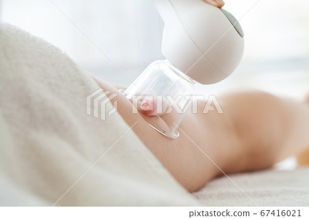 Woman getting LPG massage for skin care in beauty studio 67416021