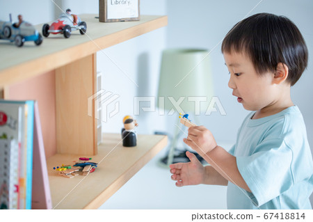 A little boy playing alone in a children's room boy kids abuse 67418814