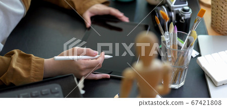 Female designer drawing on digital tablet with Female designer drawing on digital tablet with 67421808