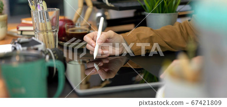 Female designer working with digital tablet on Female designer working with digital tablet on 67421809