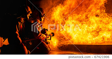 Firefighters use twirl water fog spraying down Firefighters use twirl water fog spraying down 67421906
