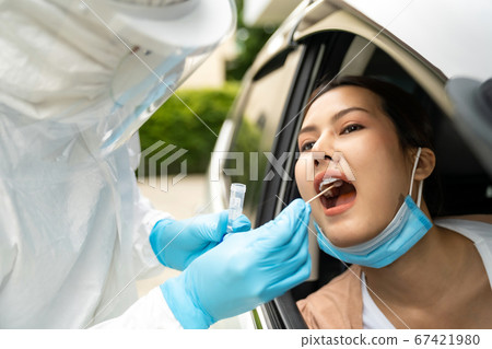 Asian woman Drive Thru covid-19 testing with PPE Asian woman Drive Thru covid-19 testing with PPE 67421980