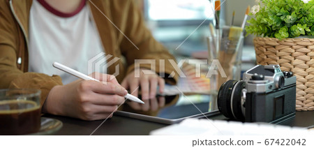 Side view of female designer working with digital Side view of female designer working with digital 67422042