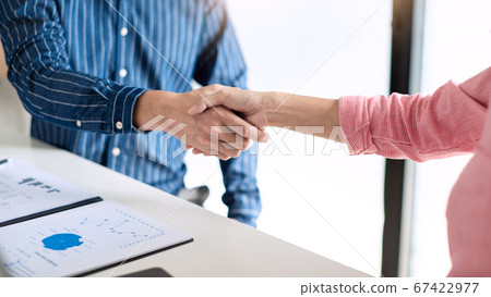 Two confident business man shaking hands during a Two confident business man shaking hands during a 67422977