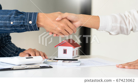House developers and customer shaking hand after House developers and customer shaking hand after 67423062