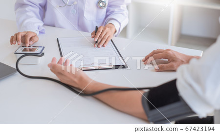 Doctor measuring and checking blood pressure of Doctor measuring and checking blood pressure of 67423194