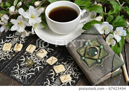 Tarot cards layout with runes and book of spells on witch table. Esoteric, gothic and occult background with magic objects, mystic and fairy tale concept Tarot cards layout with runes and book of spells on witch table. Esoteric, gothic and occult background with magic objects, mystic and fairy tale concept 67423494