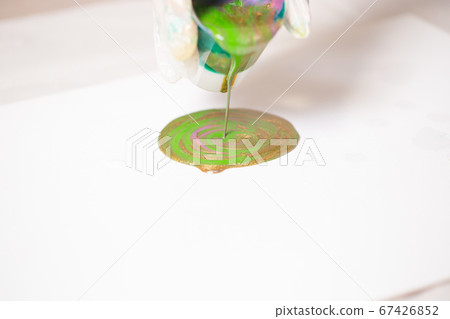 The girl creates a picture with abstraction in bright colors. The girl creates a picture with abstraction in bright colors. 67426852