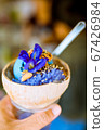 This is a kind of dessert that has ice cream and sticky rice, with flowers on top. 67426984